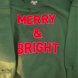 Green Sweatshirt with Red 'Merry & Bright' Text